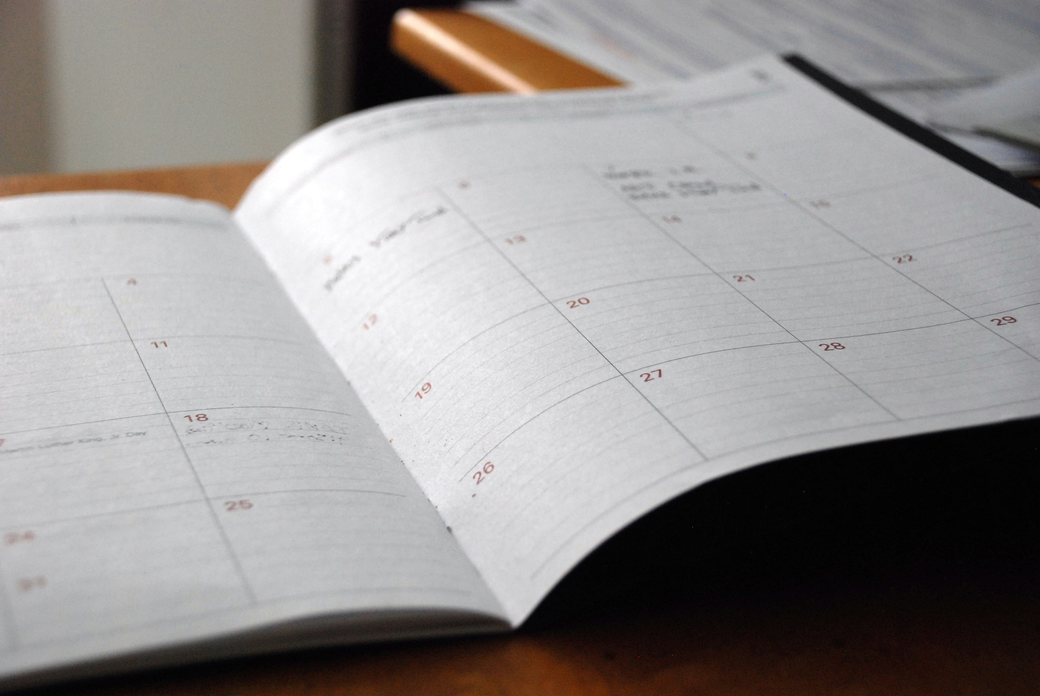 Open monthly planner on wooden desk